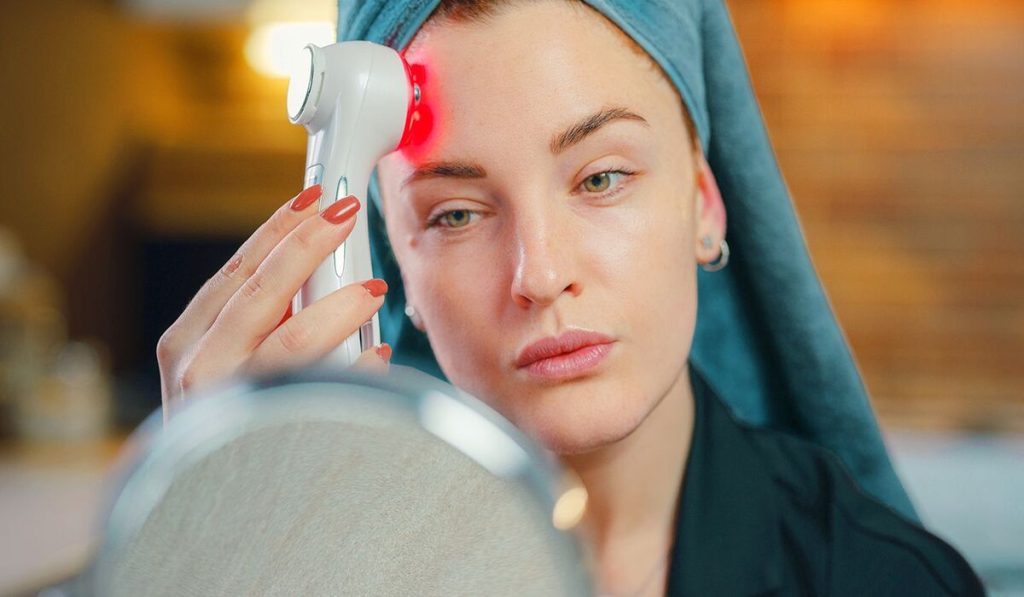 Woman using red light device