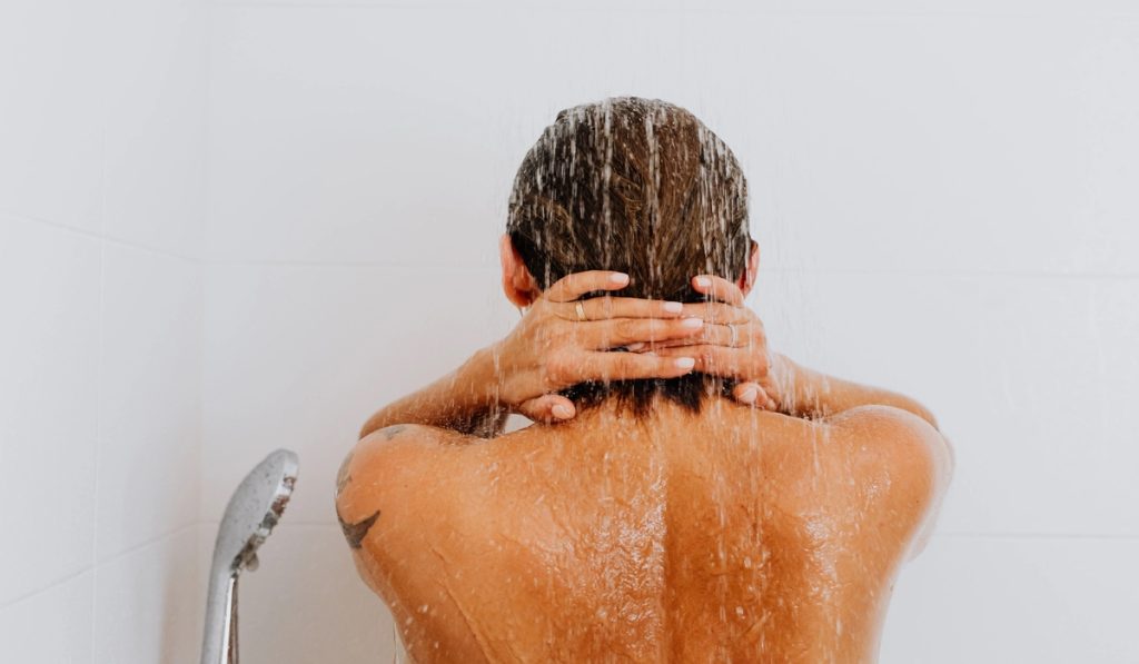 Woman taking cold shower