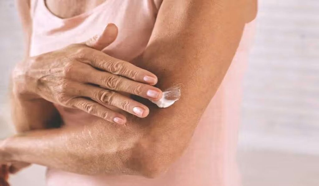 Woman treating her skin with moisturizer